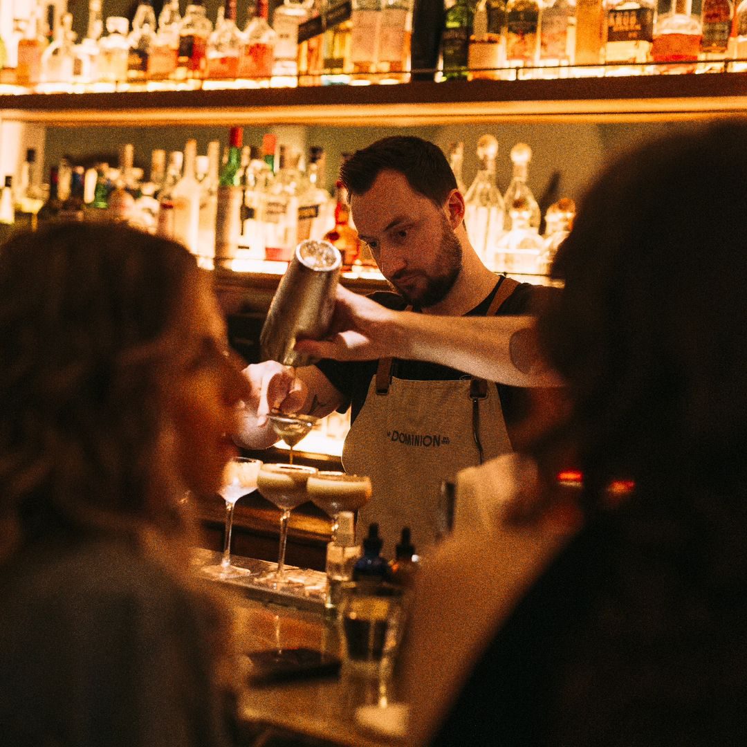 Bartender preparing cocktails at Bar Dominion, downtown Montreal.