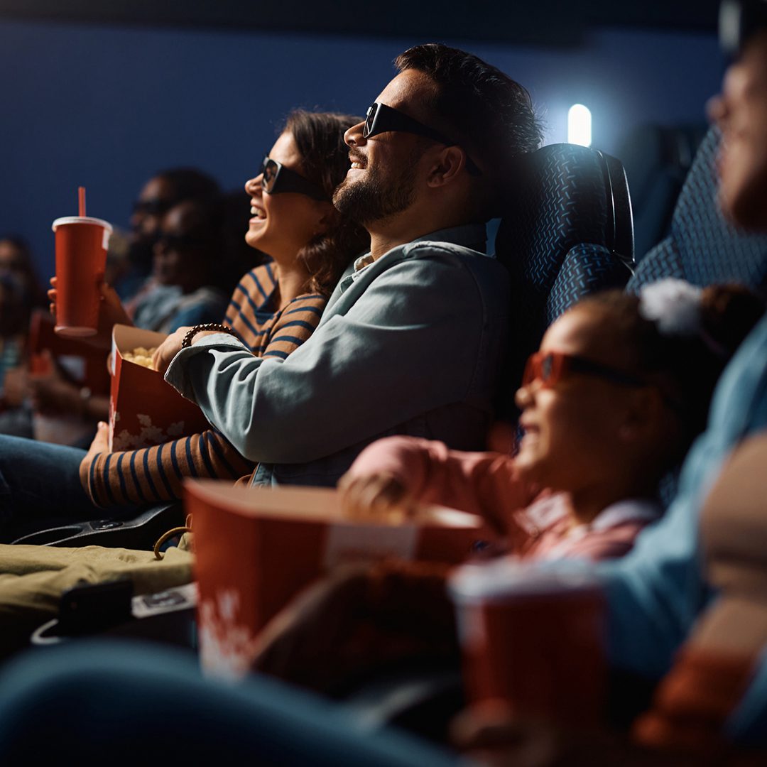 Family enjoying a movie at Cinéma Banque Scotia on Sainte-Catherine, downtown Montreal