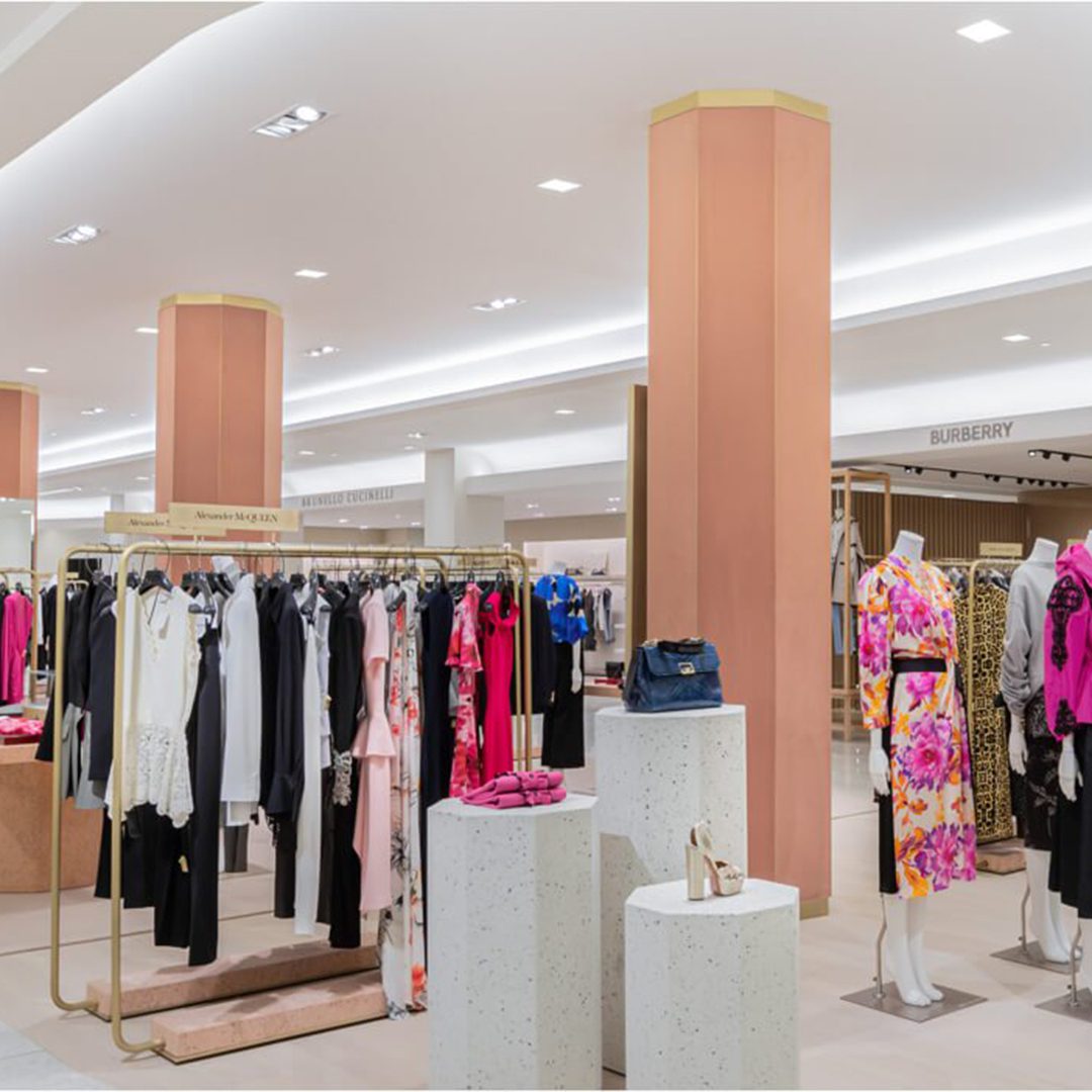 Luxury fashion section at Holt Renfrew Ogilvy, featuring designer brands like Alexander McQueen and Burberry, in Montreal.