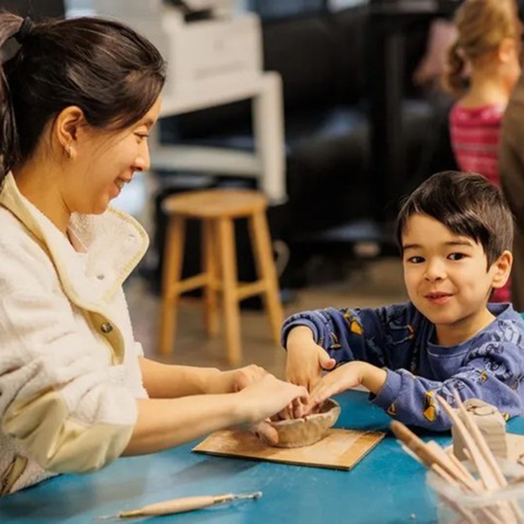 Child participating in a creative workshop with a parent during Family Saturdays at the MMFA, downtown Montreal.