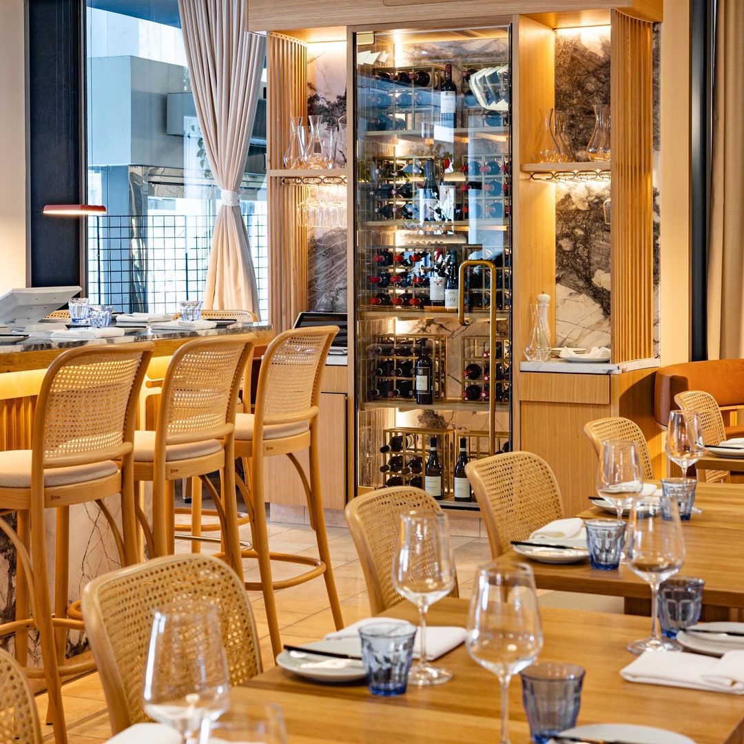 Sea-Me: Elegant dining room with a wine display.