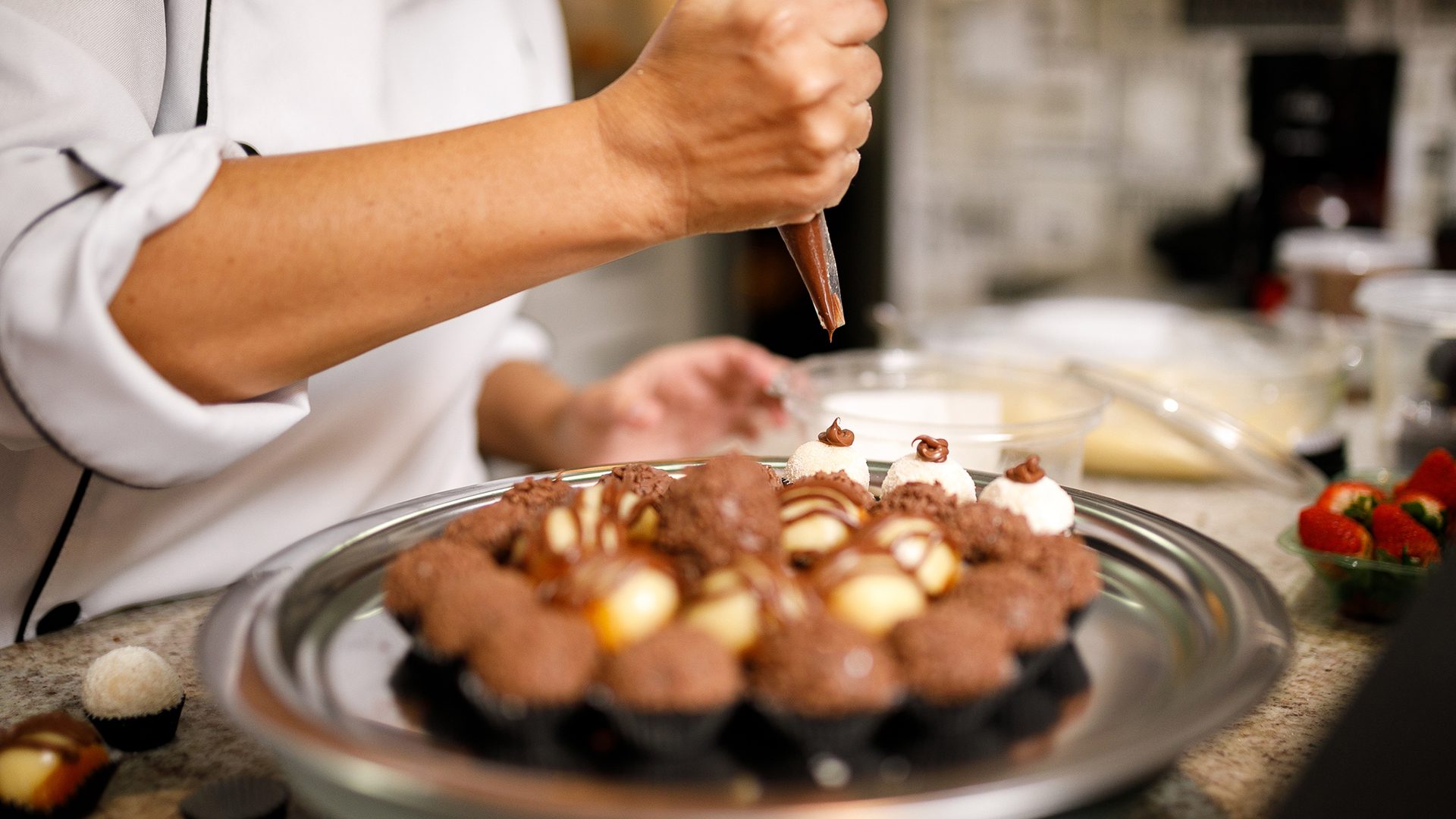 Pastry chef decorating chocolates during a workshop at the Salon du Chocolat in Montreal