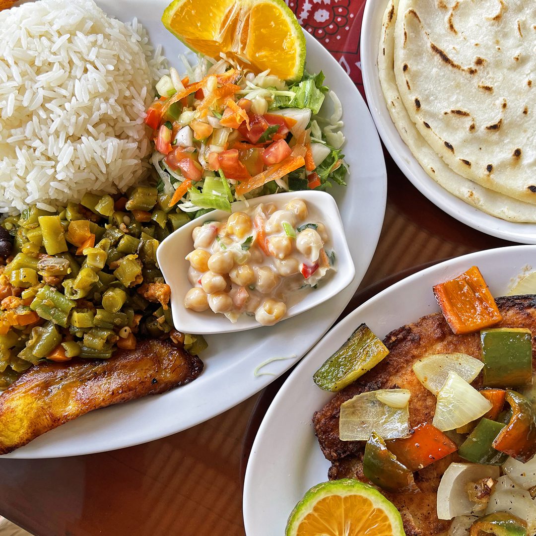 Plate of rice, vegetables, salad, chickpeas, and tortillas.