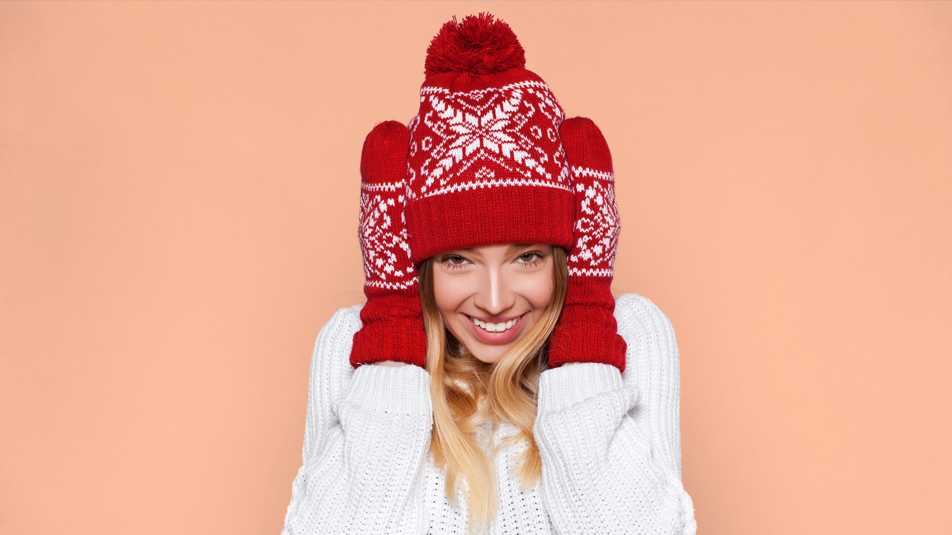 Femme souriante en bonnet rouge, esprit hivernal chaleureux.