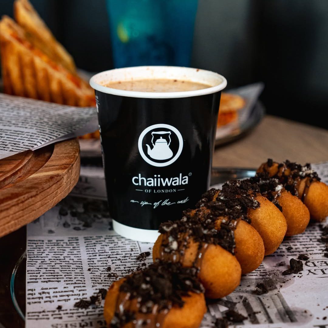 Steaming chai and chocolate-drizzled donuts at Chaiiwala of London.