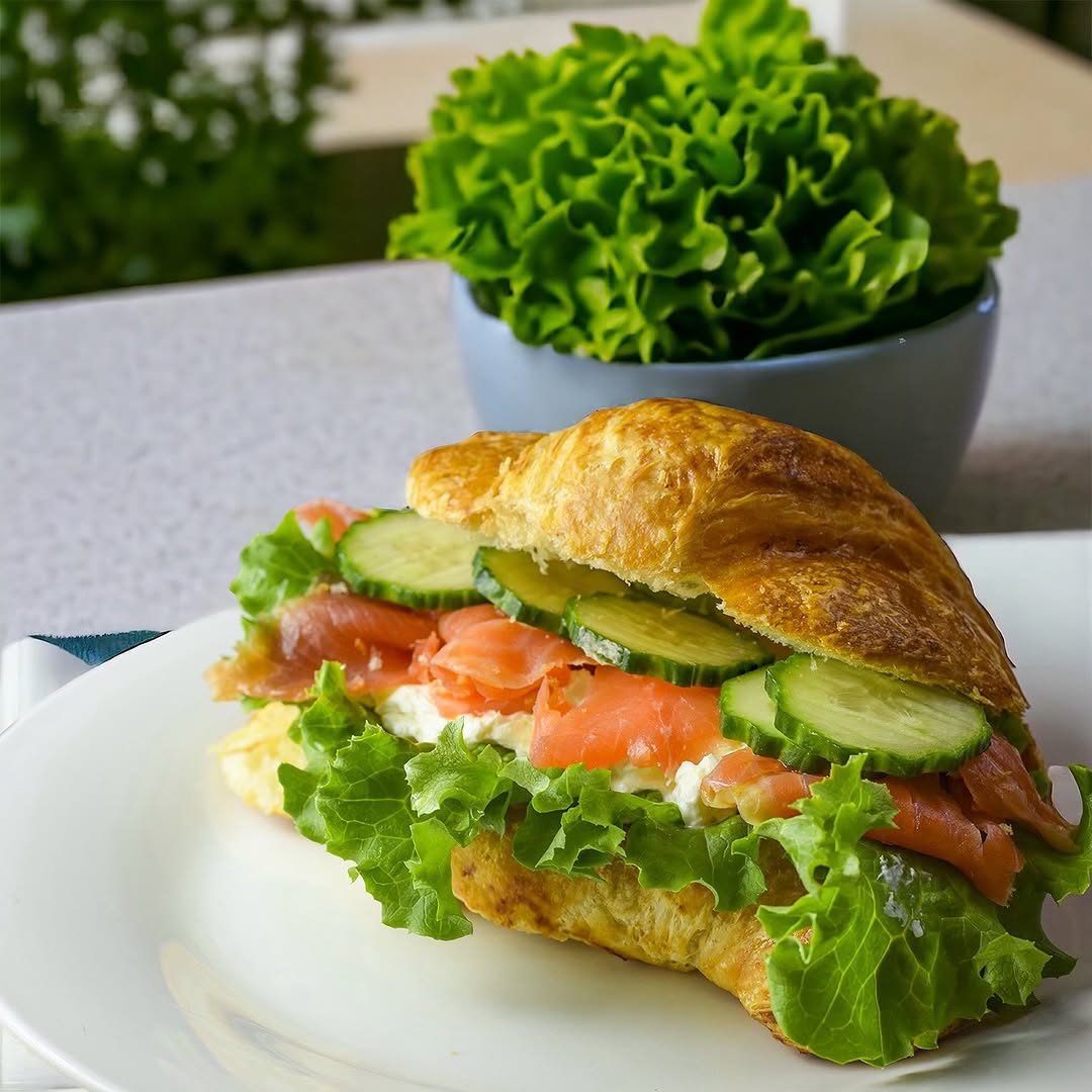 Croissant filled with smoked salmon, cream cheese, and cucumbers at Croissant’wich.