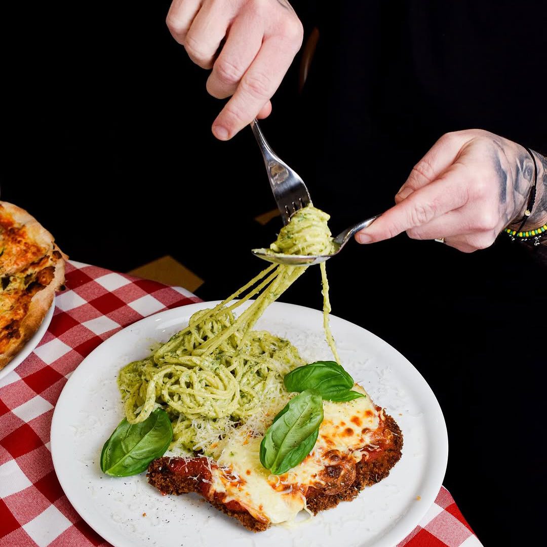 Gratinated chicken parmesan with pesto pasta at Osteria Schiavio.