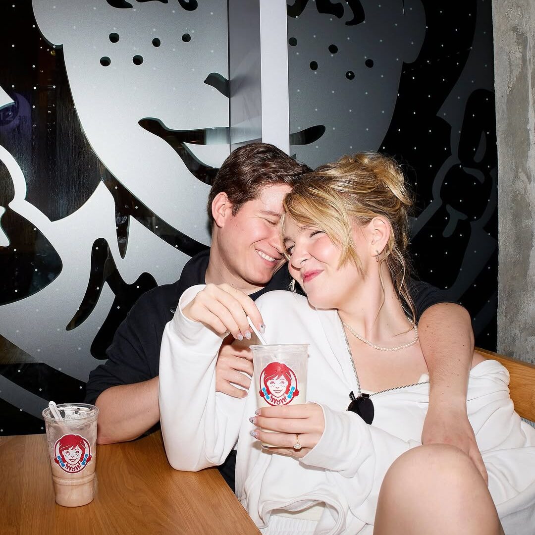 Un couple s'enlace en buvant des boissons glacées.